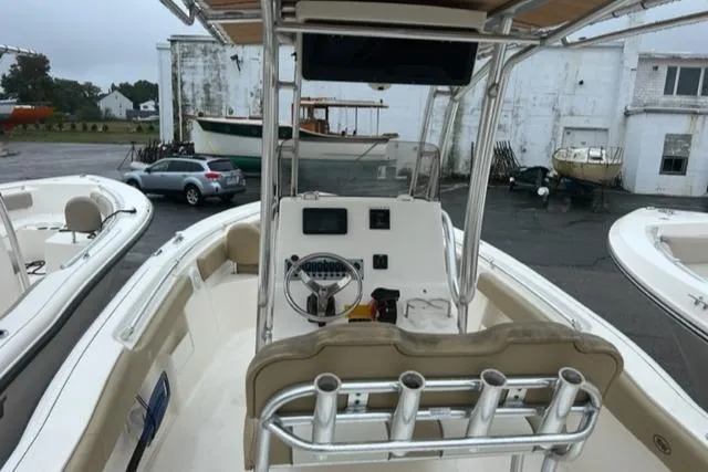 Slide: The Image of 2020 Key West 239 FS boat with center console and rod holders, parked outdoors. - 3