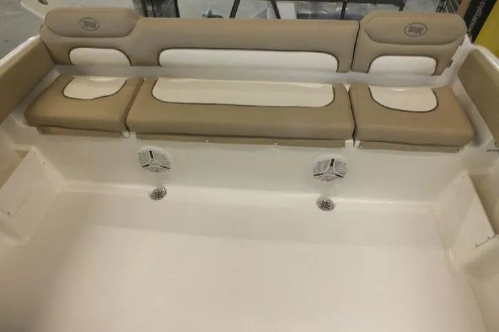 Slide: The Image of 2020 Key West 239 FS boat interior with beige seating and built-in speakers. - 9