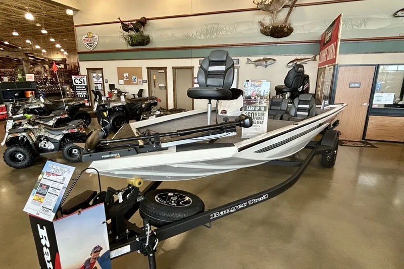 Slide: The Image of 2026 Ranger RT188 boat displayed in showroom with fishing gear and ATVs. - 3