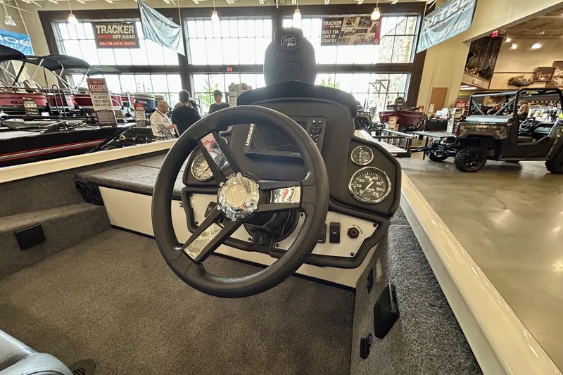 Slide: The Image of 2026 Ranger RT188 boat dashboard with steering wheel and gauges in showroom. - 2