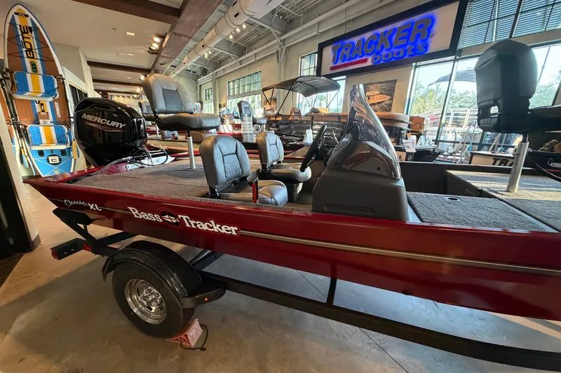 Slide: The Image of 2026 Tracker Bass Tracker Classic XL boat displayed in showroom with Mercury engine. - 3