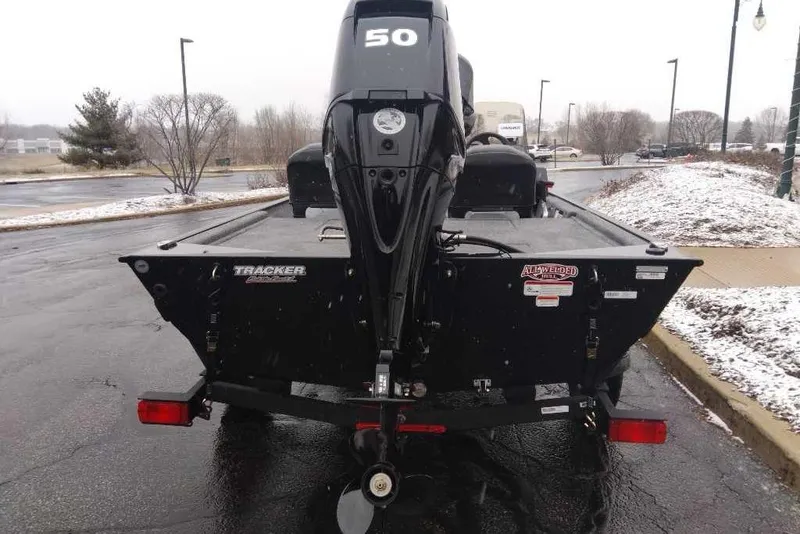 Slide: The Image of 2026 Tracker Bass Tracker Classic XL boat with 50 HP motor in snowy parking lot. - 4
