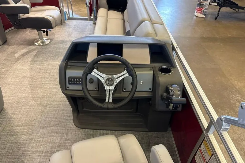 Slide: The Image of 2026 Sun Tracker SportFish 20 DLX boat interior with steering wheel and seating. - 1