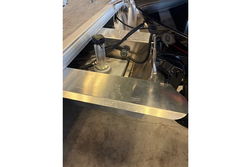 Slide: The Image of 2026 Sun Tracker SportFish 20 DLX boat engine compartment with visible components and wiring. - 105