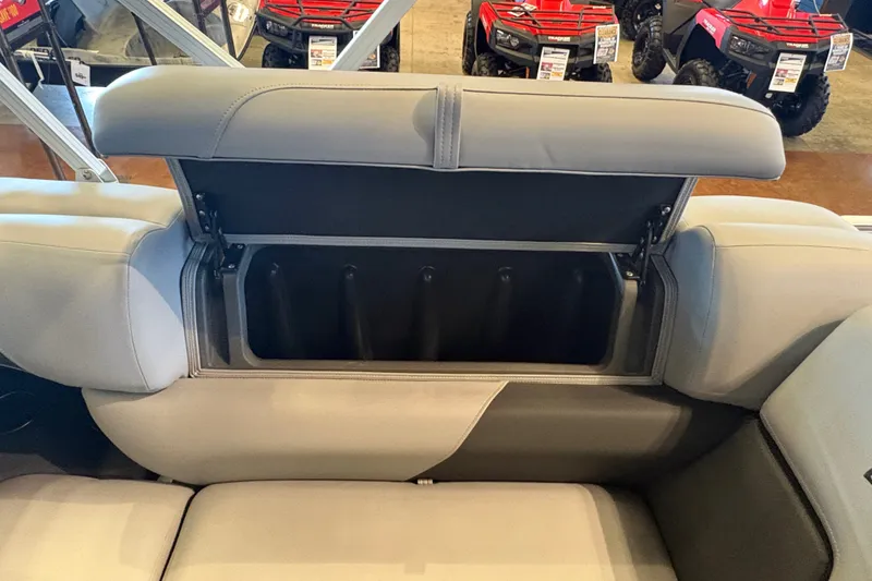 Slide: The Image of 2026 Sun Tracker SportFish 20 DLX boat seat storage compartment open, showcasing interior space. - 18