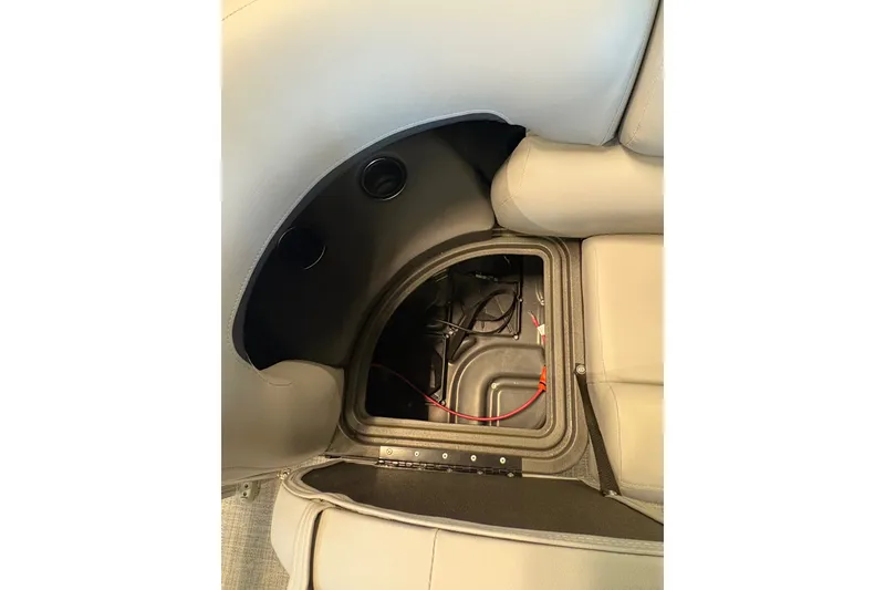 Slide: The Image of 2026 Sun Tracker SportFish 20 DLX storage compartment with wiring and seating detail. - 14