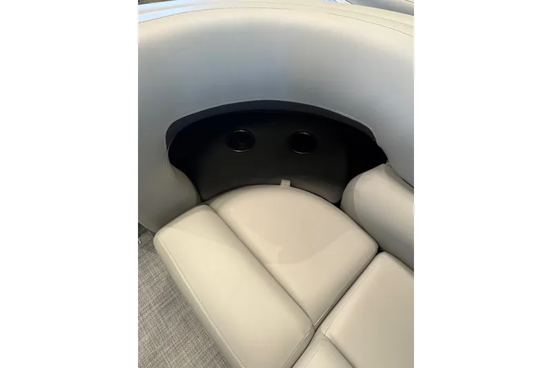 Slide: The Image of 2026 Sun Tracker SportFish 20 DLX boat interior with plush seating and cup holders. - 13