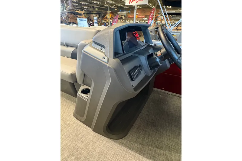 Slide: The Image of 2026 Sun Tracker SportFish 20 DLX boat console with steering wheel and controls. - 19