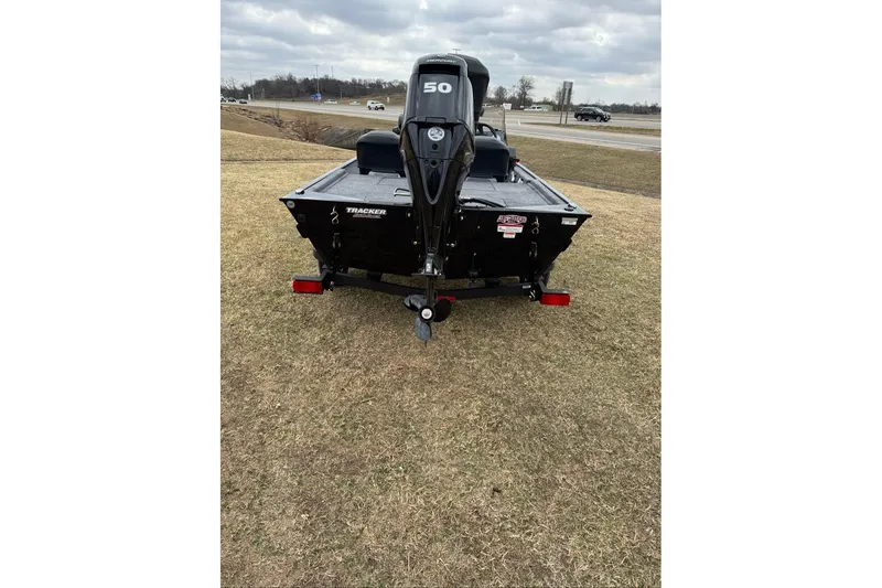Slide: The Image of 2026 Tracker Bass Tracker Classic XL boat on grassy field, rear view. - 6