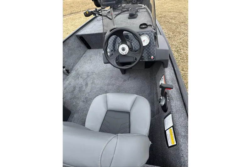 Slide: The Image of 2026 Tracker Bass Tracker Classic XL boat interior with steering wheel and seat. - 8
