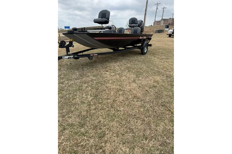 Slide: The Image of 2026 Tracker Bass Tracker Classic XL boat on trailer, parked on grass. - 2