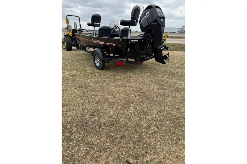 Slide: The Image of 2026 Tracker Bass Tracker Classic XL boat on grassy field, rear view. - 7