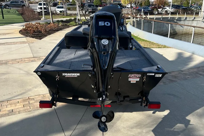 Slide: The Image of 2026 Tracker Bass Tracker Classic XL boat with 50 HP engine, parked outdoors. - 10