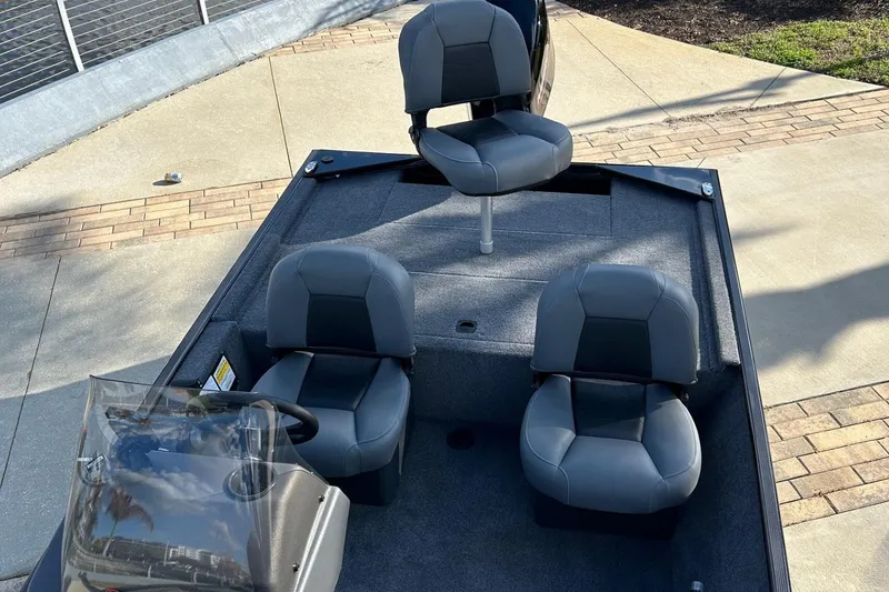 Slide: The Image of 2026 Tracker Bass Tracker Classic XL boat interior with three gray seats. - 5