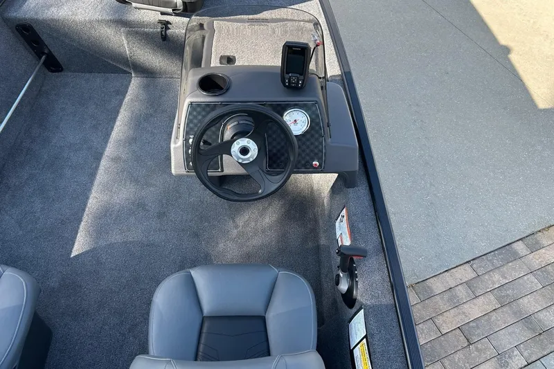 Slide: The Image of 2026 Tracker Bass Tracker Classic XL boat interior with steering wheel and dashboard. - 7