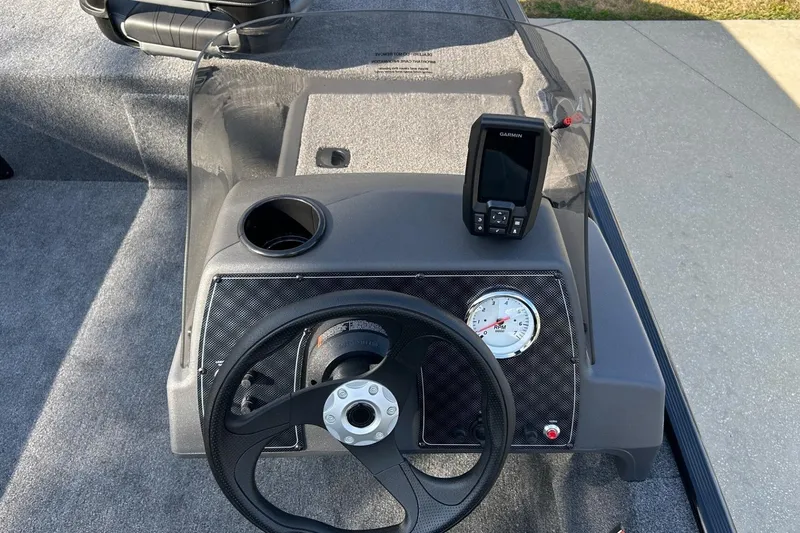 Slide: The Image of 2026 Tracker Bass Tracker Classic XL dashboard with steering wheel and Garmin device. - 8