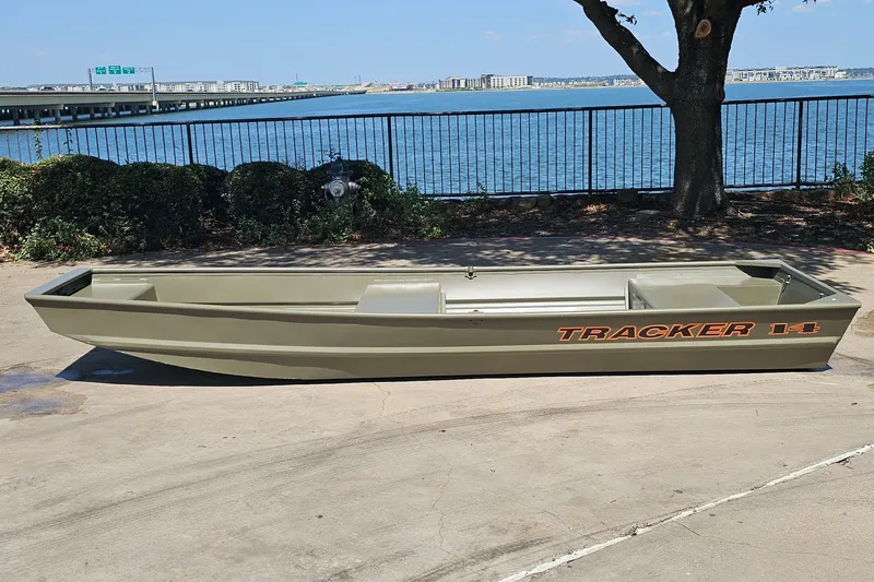 The Image of 2026 Tracker Grizzly 14 Jon boat on concrete near waterfront. - 0