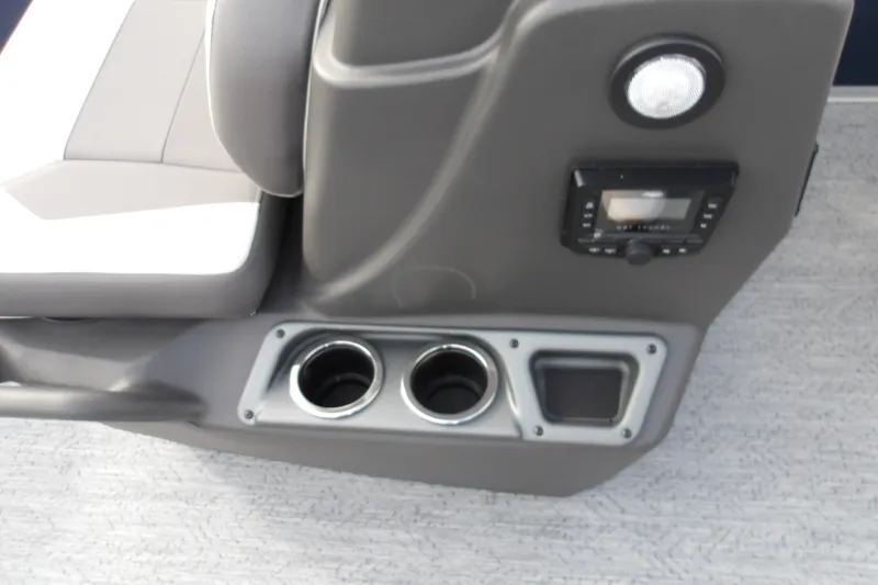 Slide: The Image of 2026 Sun Tracker Bass Buggy 18 DLX boat interior with cup holders and control panel. - 21