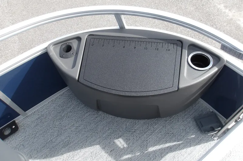 Slide: The Image of 2026 Sun Tracker Bass Buggy 18 DLX boat deck with ruler and cup holder. - 24