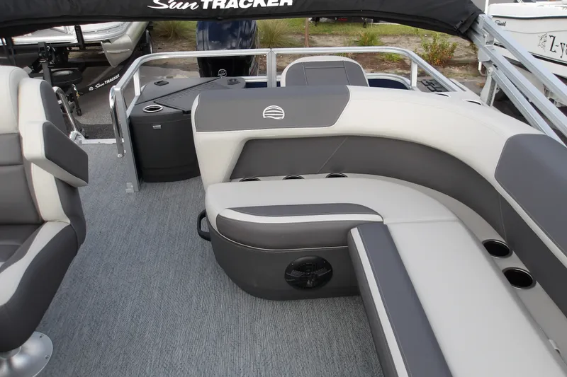 Slide: The Image of 2026 Sun Tracker Bass Buggy 18 DLX pontoon boat interior with gray seating and cup holders. - 14