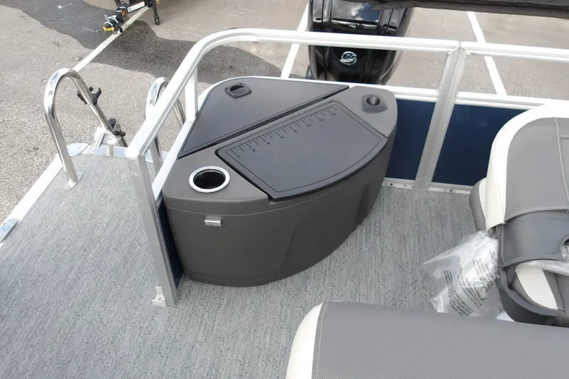 Slide: The Image of 2026 Sun Tracker Bass Buggy 18 DLX interior with storage compartment and seating. - 16
