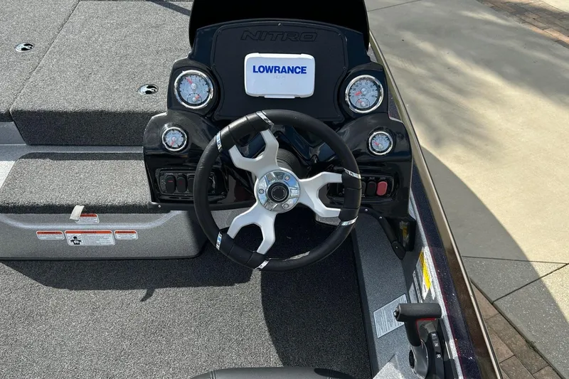 Slide: The Image of 2025 Nitro Z17 boat dashboard with steering wheel and Lowrance display. - 6