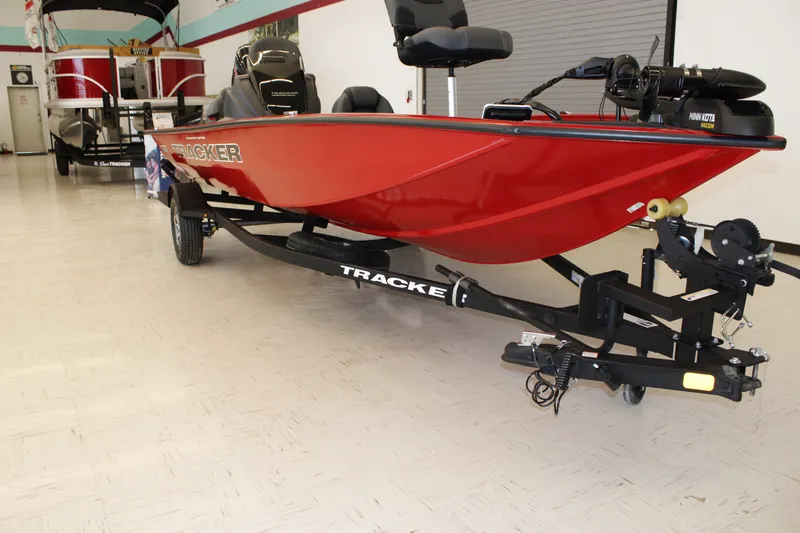 Slide: The Image of 2026 Tracker Pro Team 190 boat in showroom, red hull, on trailer. - 4