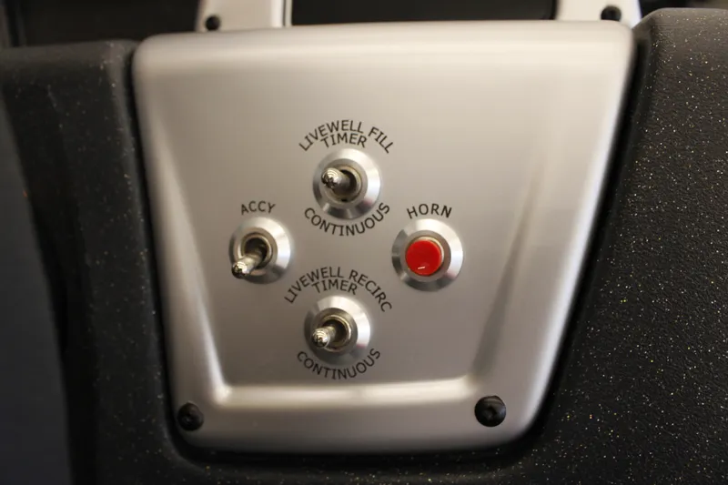 Slide: The Image of Control panel of 2026 Tracker Pro Team 190 boat with switches and horn button. - 14