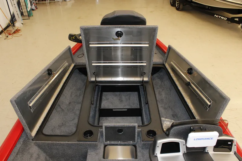 Slide: The Image of 2026 Tracker Pro Team 190 boat interior with open storage compartments and Lowrance equipment. - 7