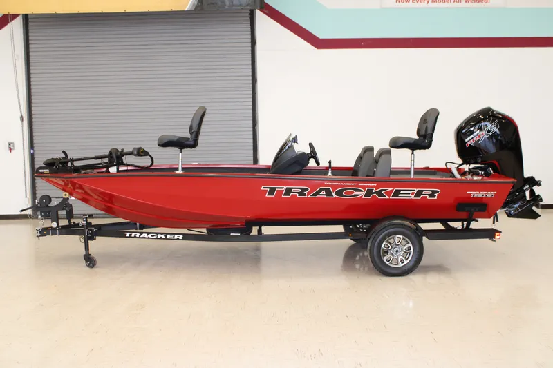 The Image of 2026 Tracker Pro Team 190 boat, red, on trailer, side view in indoor setting. - 0