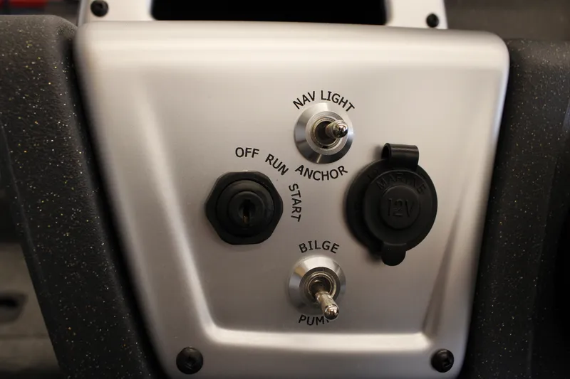 Slide: The Image of Control panel of 2026 Tracker Pro Team 190 boat with switches and 12V outlet. - 13