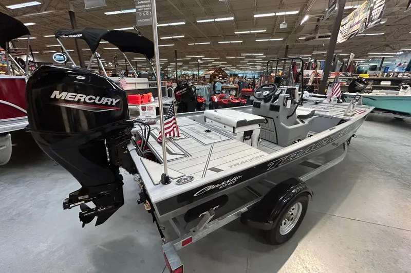 Slide: The Image of 2026 Tracker Bass Tracker Classic CC boat with Mercury engine in showroom. - 2