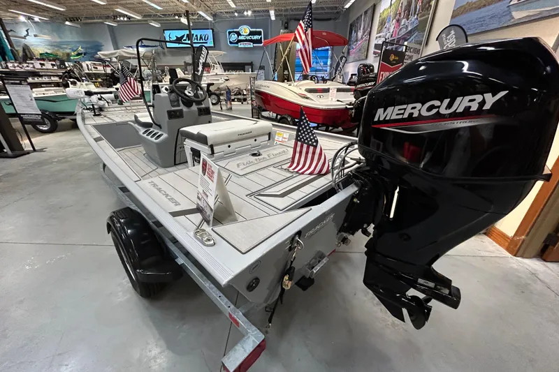 Slide: The Image of 2026 Tracker Bass Tracker Classic CC boat with Mercury engine in showroom display. - 3
