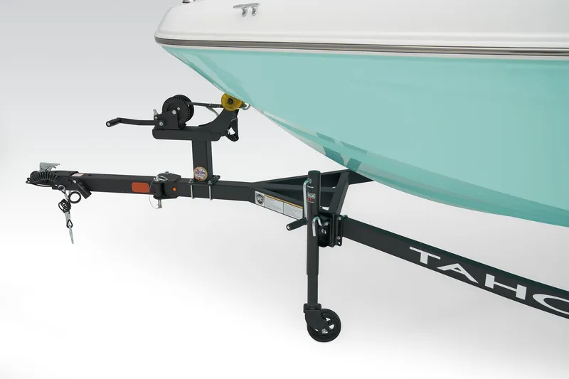 Slide: The Image of 2026 Tahoe T16 boat on trailer in parking lot, featuring sleek design and black hull. - 7
