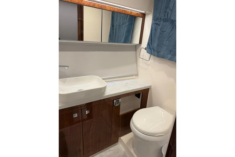 Slide: The Image of Luxurious bathroom in 2025 Riviera 50 Sports Motor Yacht with modern fixtures and elegant design. - 13