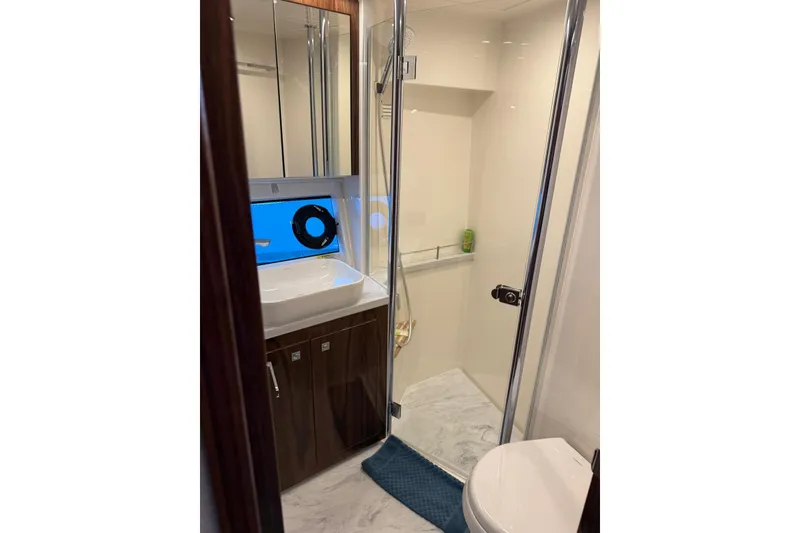 Slide: The Image of Luxurious bathroom in 2025 Riviera 50 Sports Motor Yacht with modern fixtures and elegant design. - 15