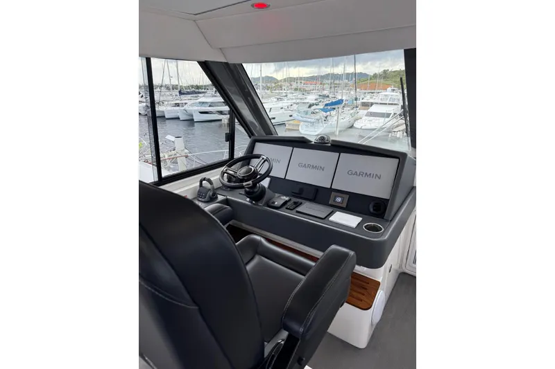Slide: The Image of Helm of 2025 Riviera 50 Sports Motor Yacht with Garmin navigation displays. - 17