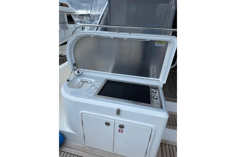 Slide: The Image of Outdoor kitchen on 2025 Riviera 50 Sports Motor Yacht with grill and sink. - 3