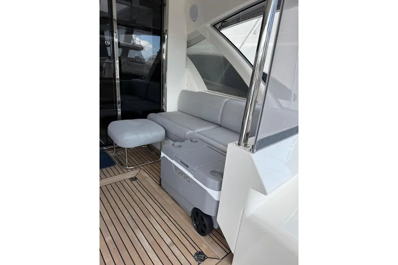 Slide: The Image of 2025 Riviera 50 Sports Motor Yacht interior with sleek seating and modern design. - 5