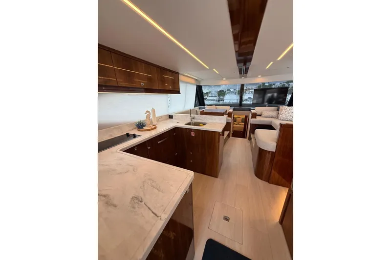 Slide: The Image of Luxurious interior of 2025 Riviera 50 Sports Motor Yacht with modern kitchen and seating area. - 9