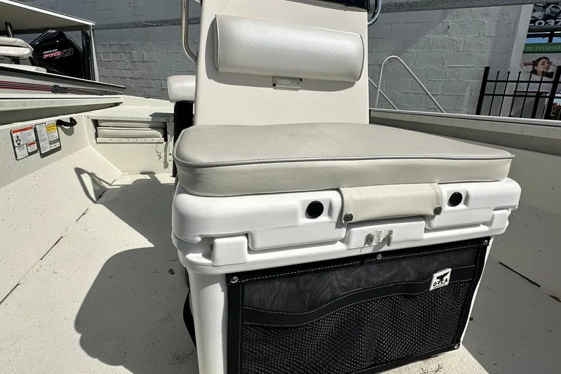 Slide: The Image of 2025 Ranger RB210 boat interior with cushioned seating and storage compartment. - 11