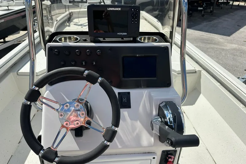 Slide: The Image of 2025 Ranger RB210 boat console with steering wheel and navigation system. - 14
