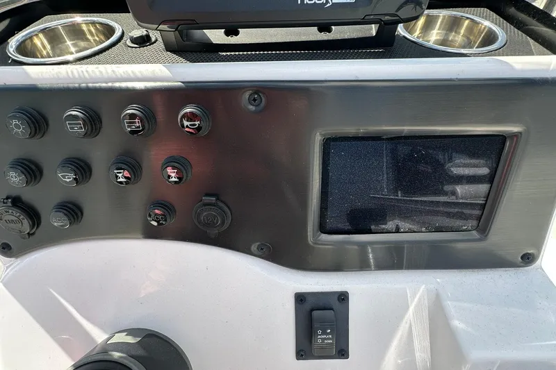 Slide: The Image of Control panel of 2025 Ranger RB210 boat with switches and display screen. - 16