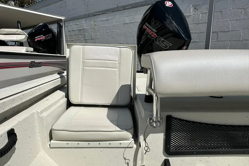 Slide: The Image of 2025 Ranger RB210 boat interior with white seating and Mercury Pro XS engine. - 21