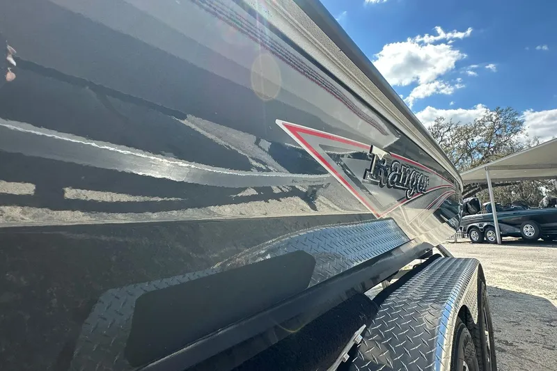 Slide: The Image of 2025 Ranger RB210 boat side view with logo, under a clear blue sky. - 24