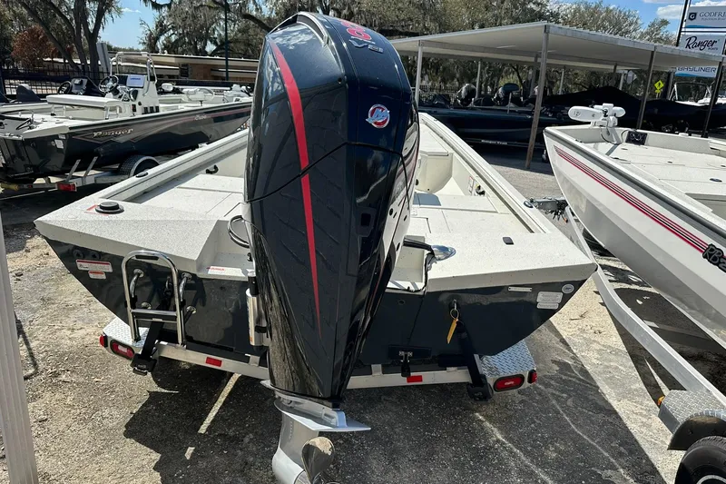 Slide: The Image of 2025 Ranger RB210 boat with powerful outboard motor, displayed outdoors. - 25