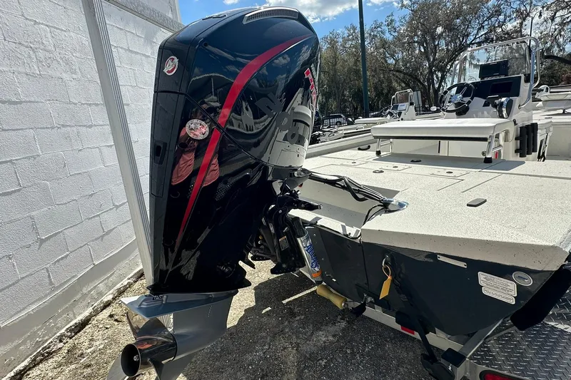 Slide: The Image of 2025 Ranger RB210 boat with powerful outboard motor, parked outdoors. - 28