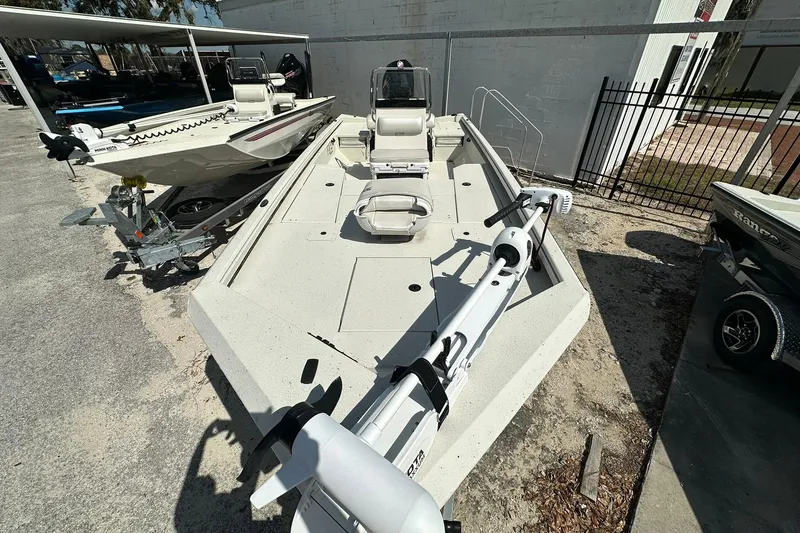 Slide: The Image of 2025 Ranger RB210 boat with trolling motor, parked on a trailer in a lot. - 4