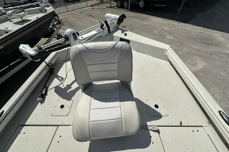 Slide: The Image of 2025 Ranger RB210 boat with a white seat and trolling motor on deck. - 7