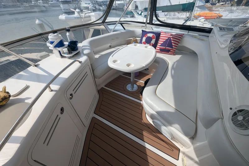 Slide: The Image of 1998 Sea Ray 480 Sedan Bridge yacht interior with seating, table, and nautical decor. - 16